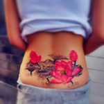 pretty watercolor paint pink black flower tattoo on lower back