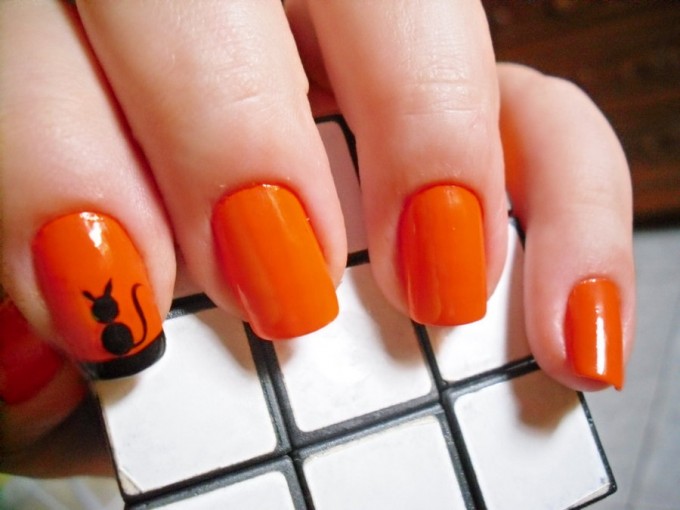 black cat silhouette on orange spooky nail art design idea