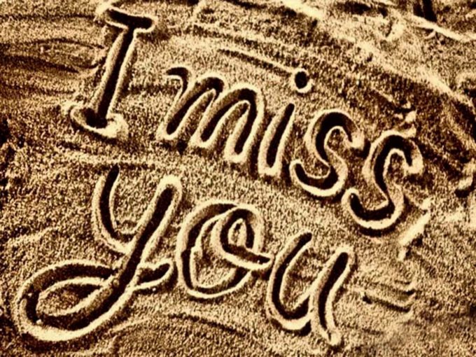 i miss you lettering on beach sand
