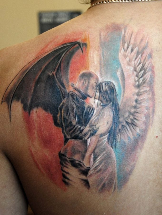 Amazing kissing angel and demon tattoo on shoulder