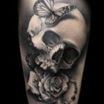 black and grey skull butterfly rose cross tattoo design