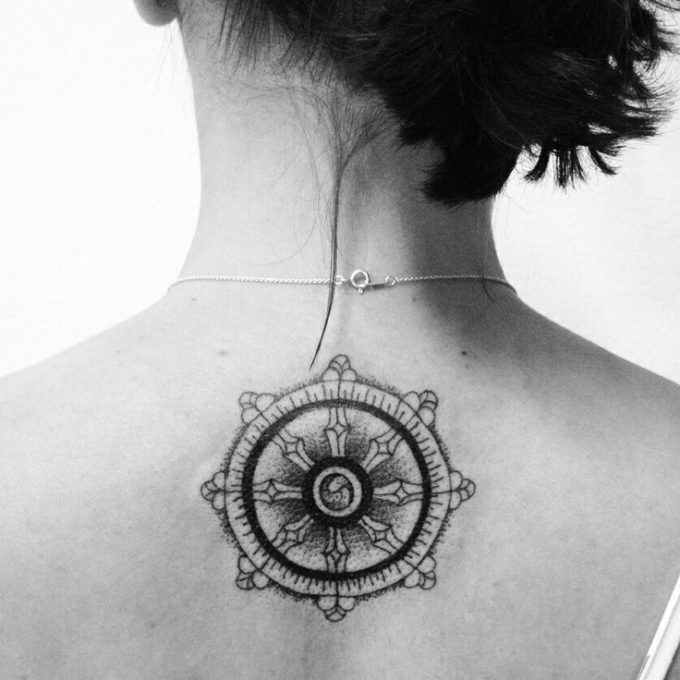 dharma wheel tattoo on back neck