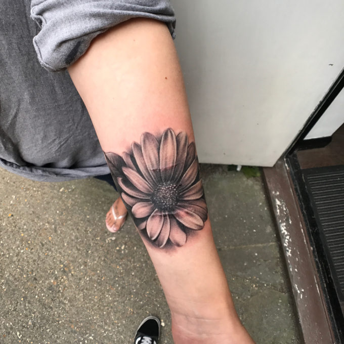 Black And Grey Aster Flower tattoo On Wrist