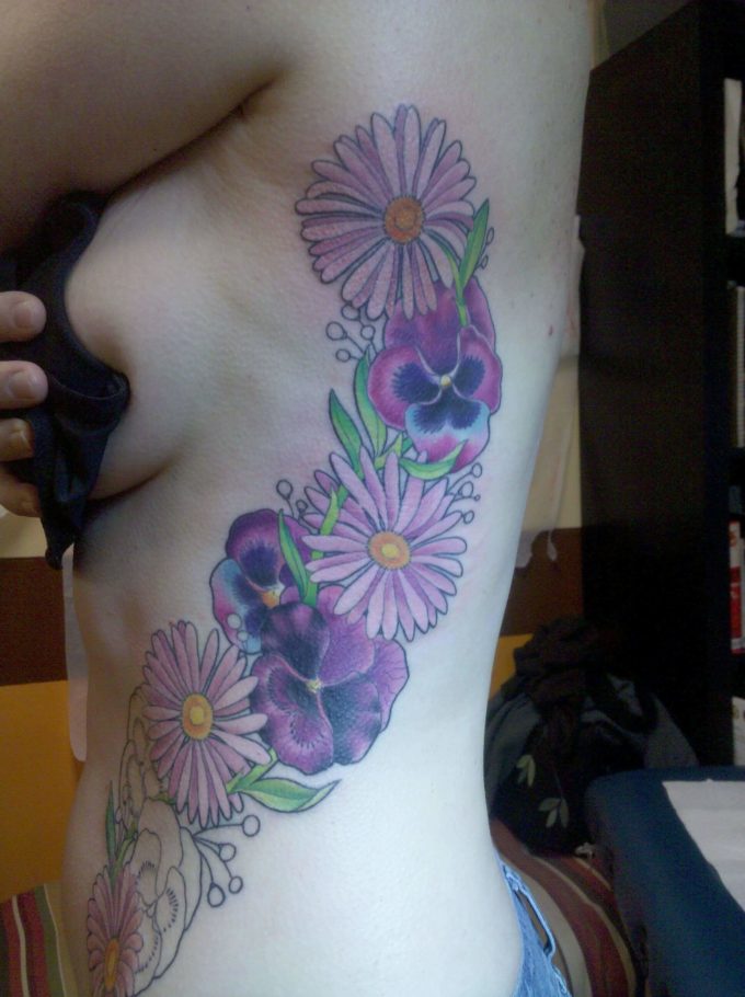 Vine Of Aster And Pansy Flowers tattoo On Side Ribs