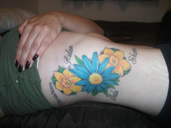 birth flowers daffodil and aster tattoo on side ribs