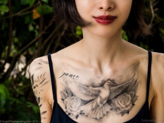 black and white dove and rose peace tattoo on chest