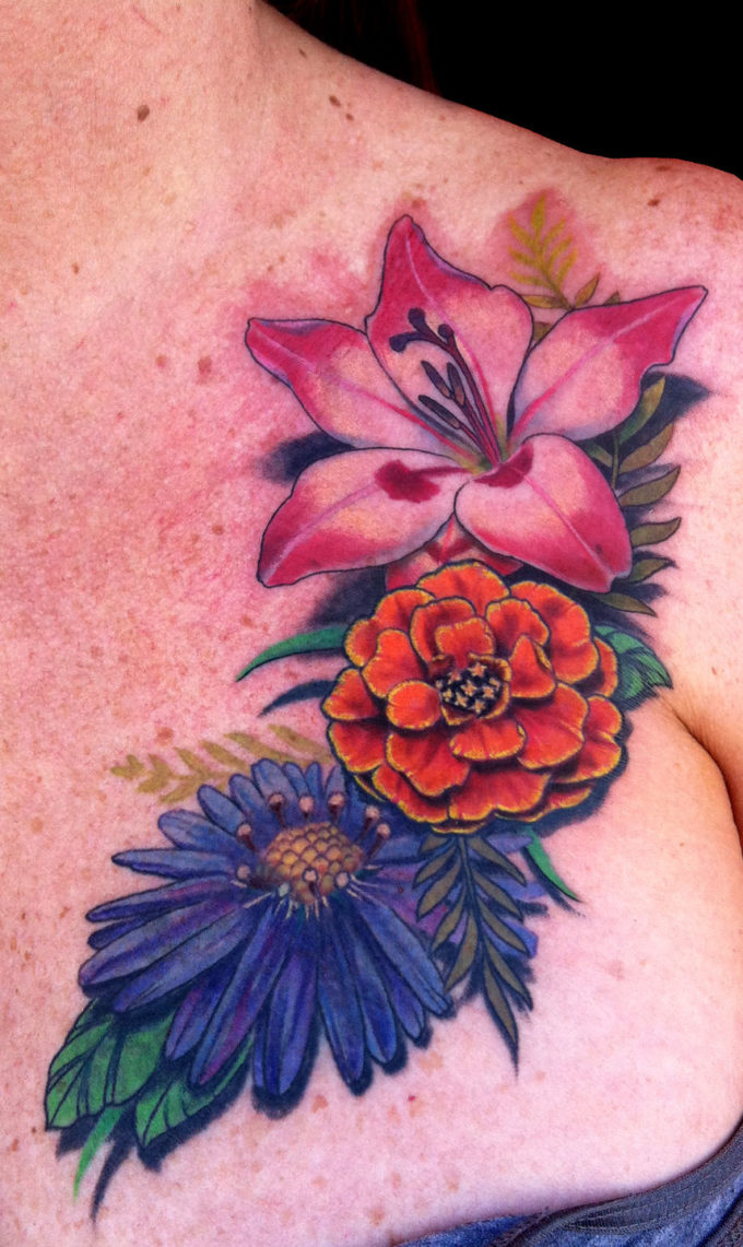 colorful flowers tattoo aster, gladiolus,marigold on chest