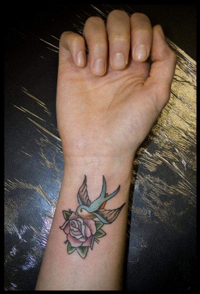 small dove and rose tattoo on wrist