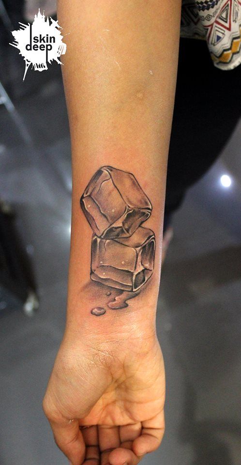 black ink ice cube tattoo on wrist