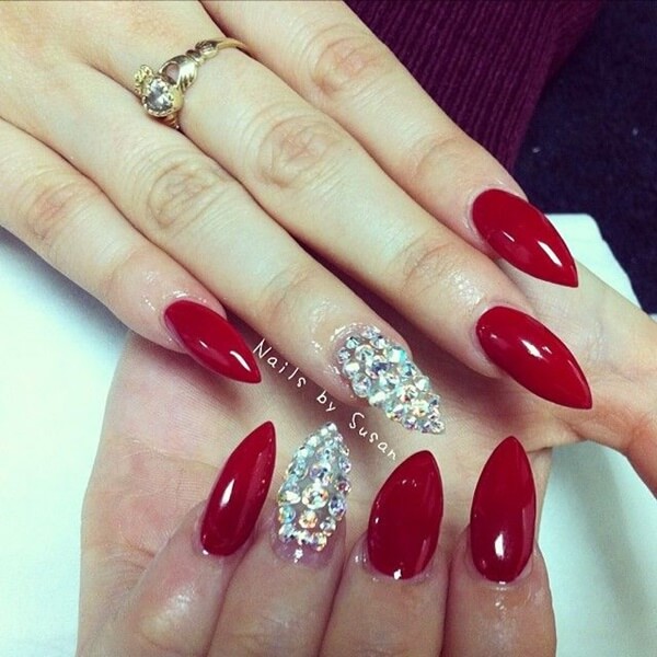 red Christmas stiletto nails with diamonds on single finger