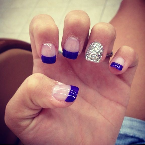 royal blue french tip nails with diamonds on one finger