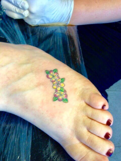 little hawaiian flowers plumeria tattoo design on foot