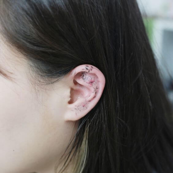 plumeria flower tattoo on ear