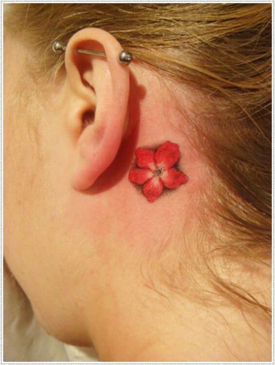 small plumeria flower tattoo behind ear