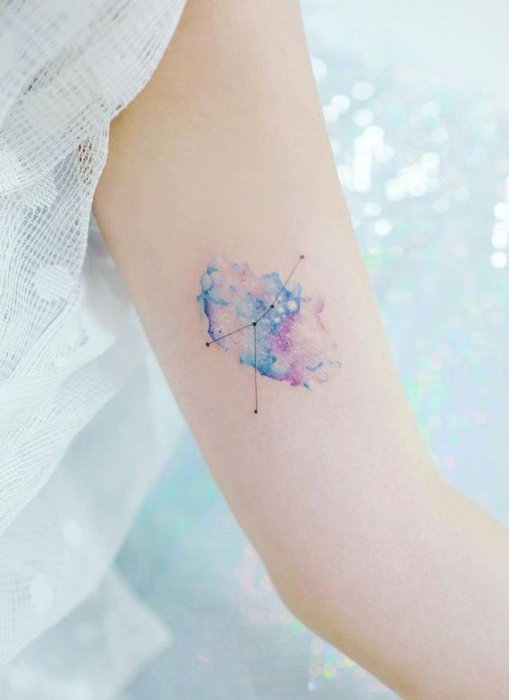 Cancer constellation and galaxy tattoo on the inner arm