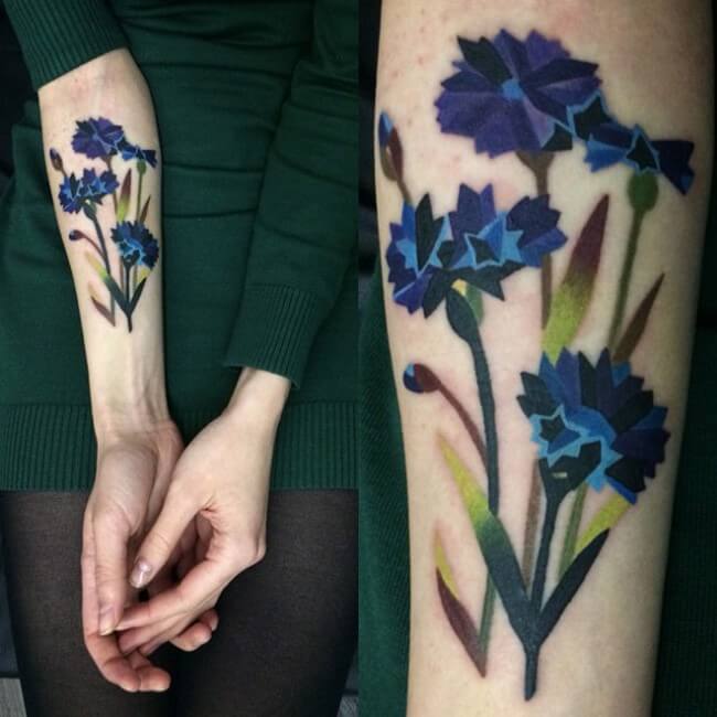 watercolor ink cornflower tattoo on forearm