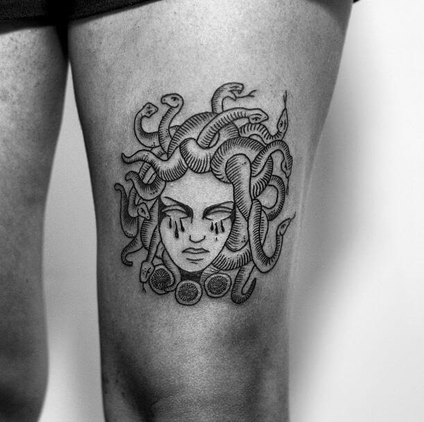 little medusa head tattoo on thigh
