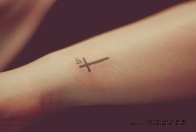 cross and heart tattoo design on side wrist
