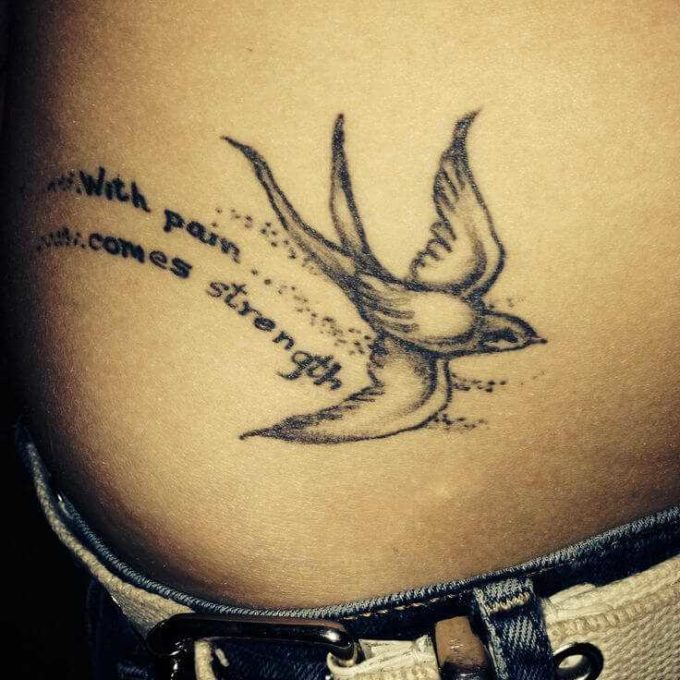 bird and with pain comes strength tattoo on side stomach