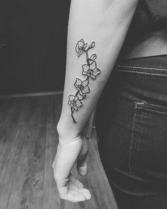 black and grey orchid flower tattoo on side forearm