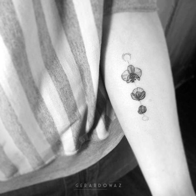 dotwork monochrome orchid tattoo on inner forearm