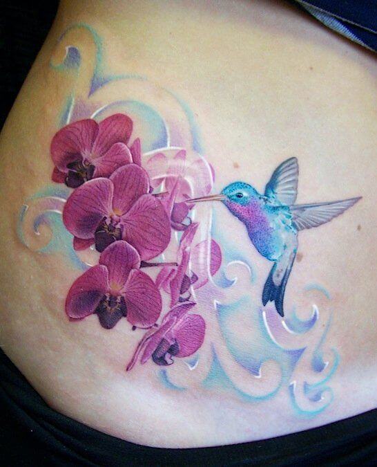 hummingbird and orchid flowers tattoo design on stomach
