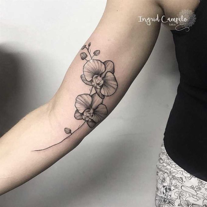 pretty outlined orchid flower tattoo design on arm