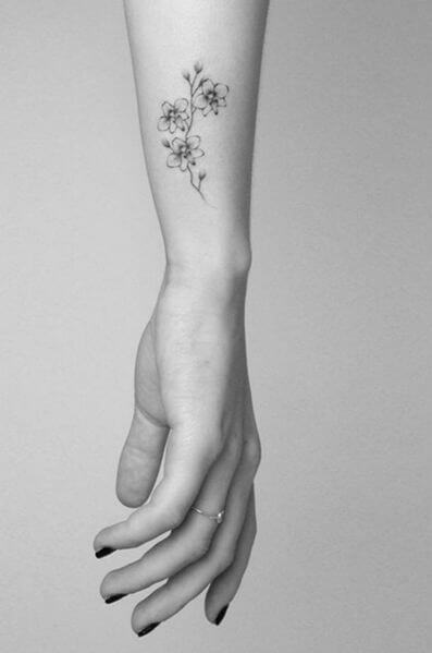 tiny monochrome orchid flowers tattoo on side wrist for females