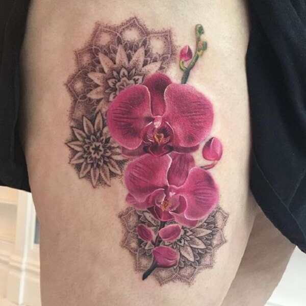 tribal orchid flower tattoo on thigh