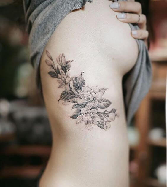 roses and jasmine floral tattoo design on ribs