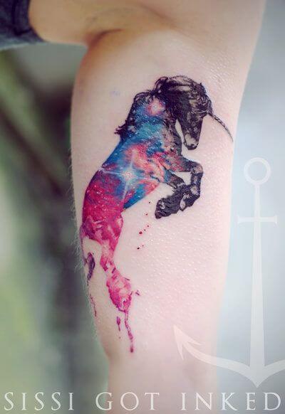 galaxy unicorn tattoo on upper arm