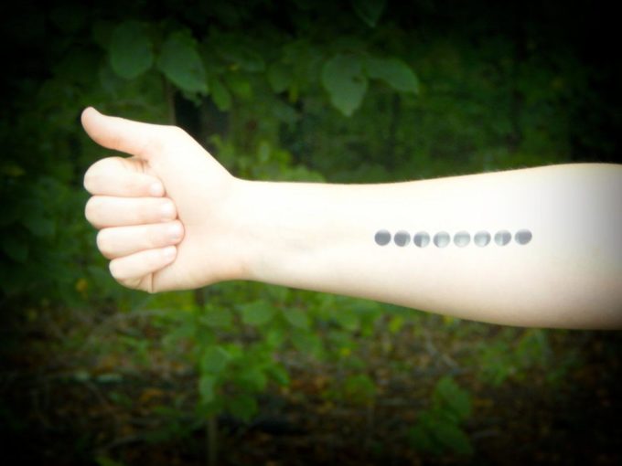 phases of the moon tattoo on forearm