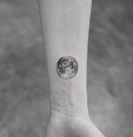 planet tattoo on wrist