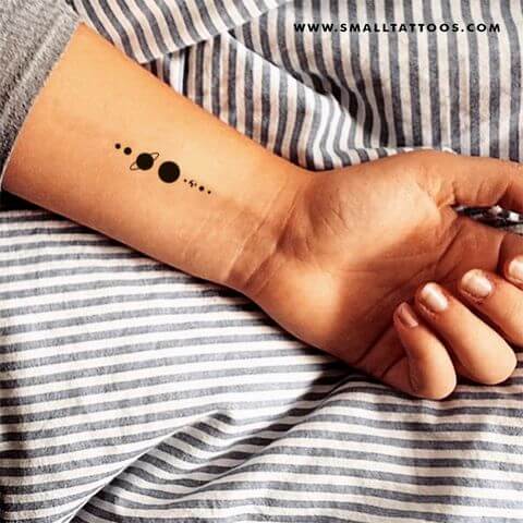 small solar system tattoo on wrist