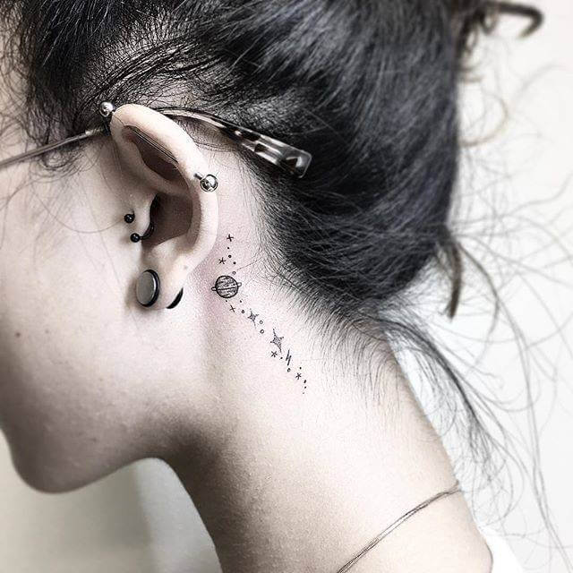 small space astronomy tattoo idea behind ear