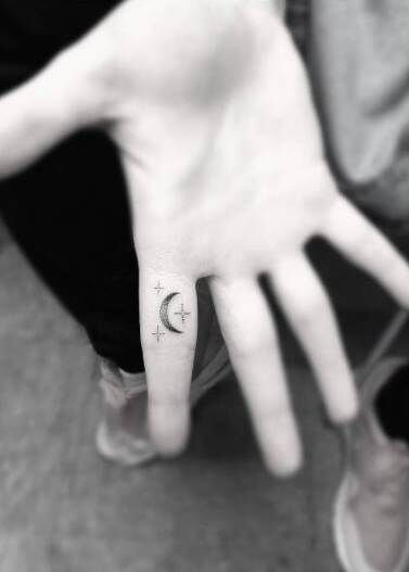 small stars and moon astronomy tattoo idea on finger