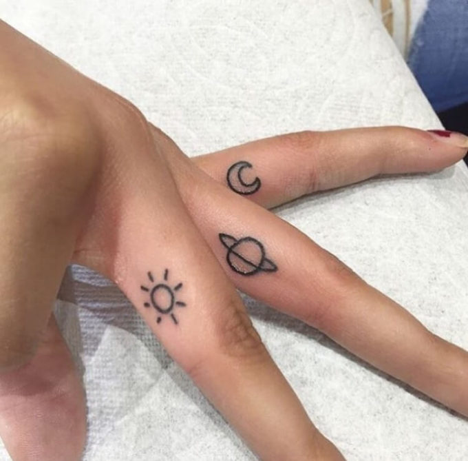 small sun moon earth astronomy tattoo on fingers