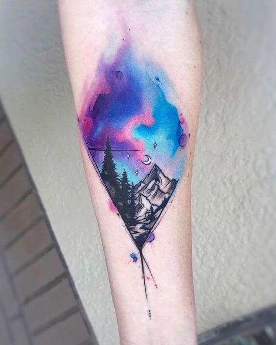 watercolor galaxy astronomy tattoo idea on forearm