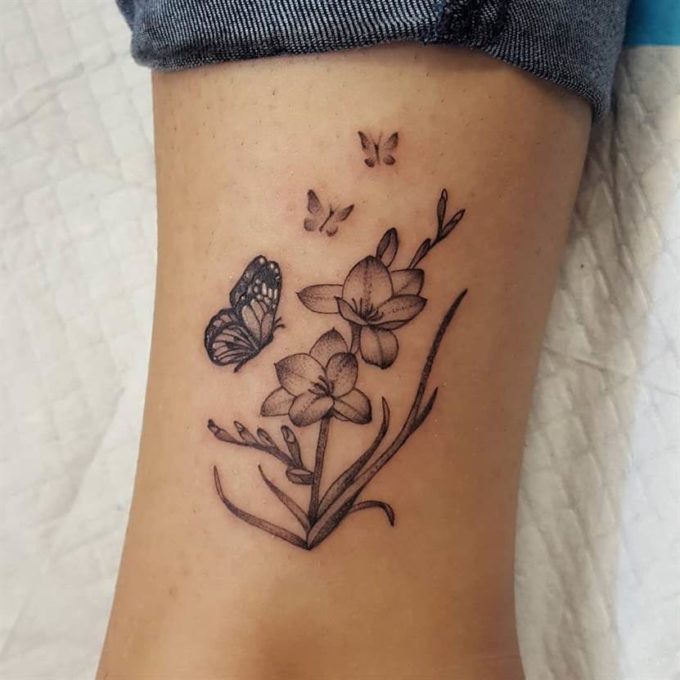 black and grey butterflies with freesia flowers tattoo design