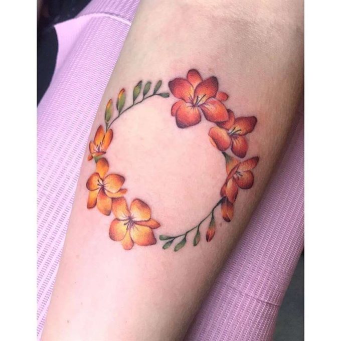 circular floral freesia flowers tattoo design