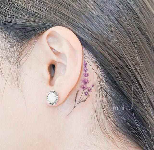 delicate small lavender sprig flower tattoo design behind ear