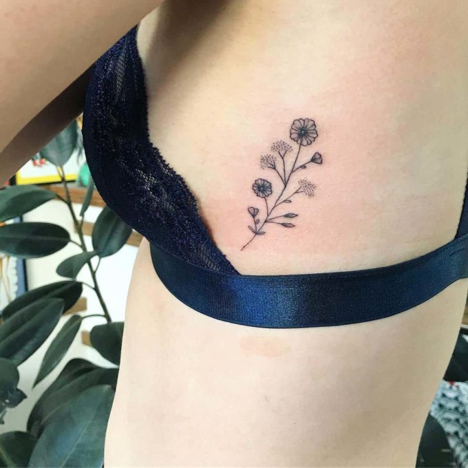lavender sprig flower tattoo on side ribs