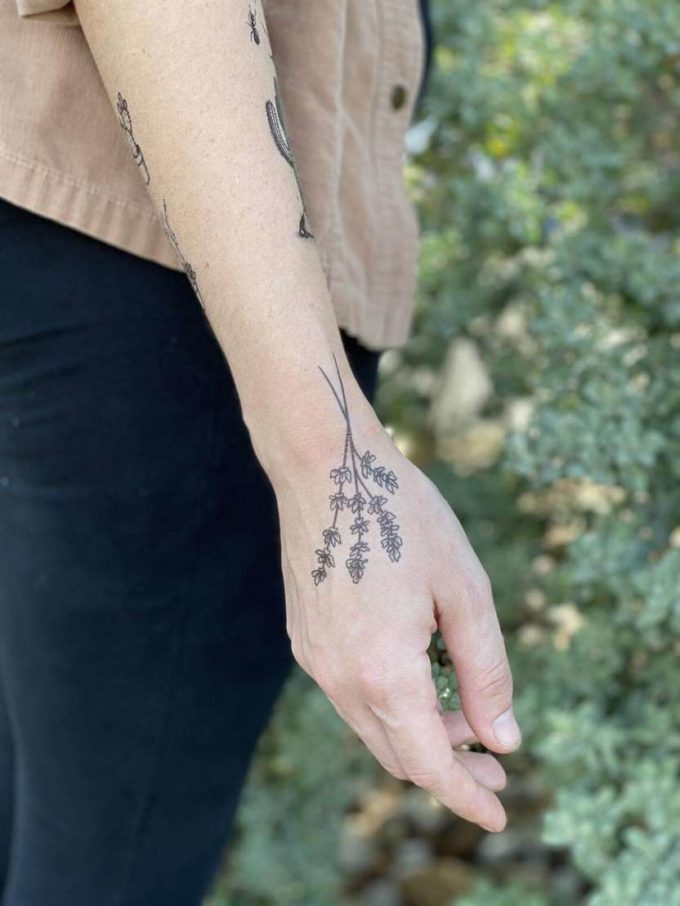 outline lavender sprig tattoo on back hand