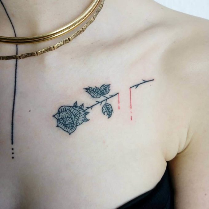 black and white rose bleeding from the thorn tattoo design on chest 