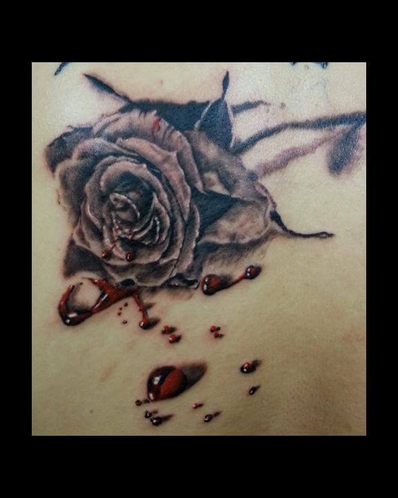 black rose bleeding with drops of red blood tattoo design