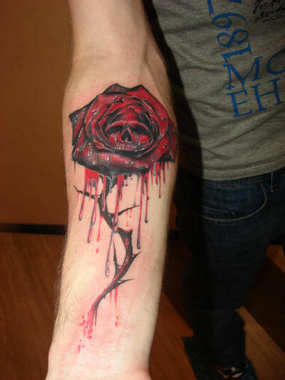 bleeding rose with skull tattoo design on forearm
