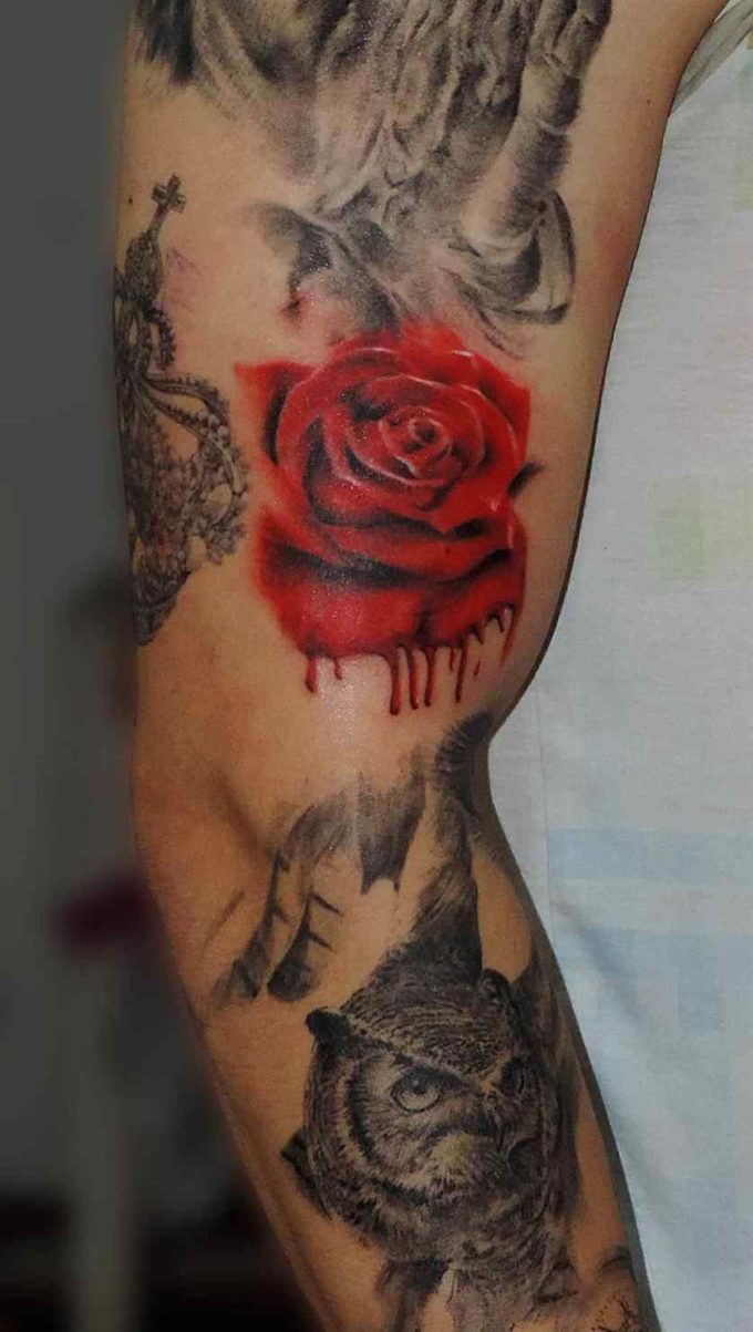 pretty red rose petals dripping with blood tattoo design on arm