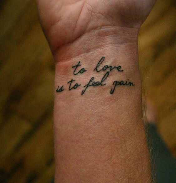 to love is to feel pain quote tattoo idea on wrist