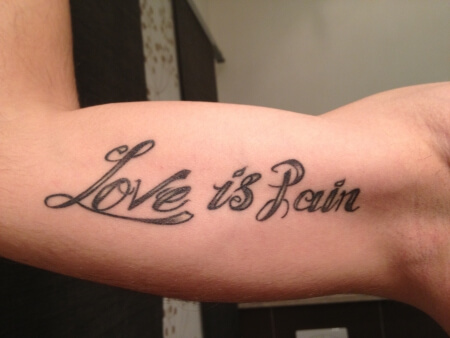 love is pain bicep tattoo idea