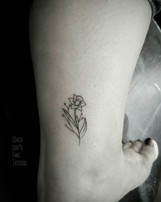 outline small december birth flower narcissus tattoo on back ankle